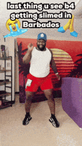 a man in red shorts and a white tank top is dancing in a room with the caption last thing u see b4