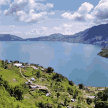 a large body of water surrounded by mountains on a sunny day