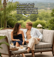 a man and a woman sit on a couch with a greeting in a foreign language