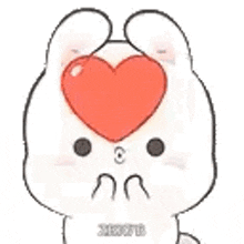 a rabbit with a heart on its head is holding a heart in its mouth .