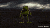 a frog is standing in the middle of a desert with red flames coming out of its arms and legs .