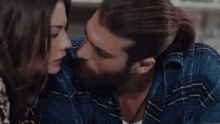 a man and a woman are sitting next to each other and talking .