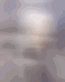 a blurry picture of a person 's face with a light coming out of it
