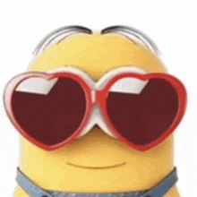 a yellow minion wearing heart shaped sunglasses .