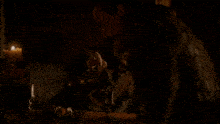 a man in a brown vest drinks from a small cup