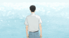a man in a white shirt is standing in front of a blue background