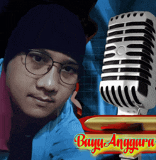 a man wearing glasses and a beanie stands in front of a microphone with the words buyu anggara on the bottom