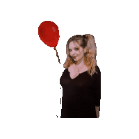 a woman in a black dress holds a red balloon in her hand