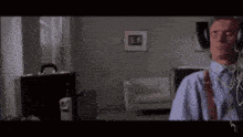 a man wearing headphones is standing in a room