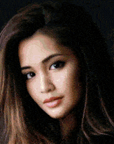 a close up of a woman 's face against a black background