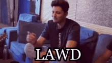 a man sitting on a couch with the word lawd written on the bottom