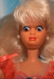 a close up of a barbie doll with a red dress