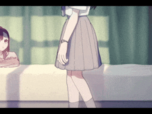 a girl in a pleated skirt is standing next to another girl
