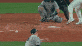 a baseball player wearing a green jersey that says reds on it