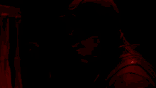 a man in a dark room with a red light on his head