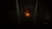 a person is standing in a dark room with a light shining through a window .