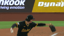a baseball player throws a ball in front of an advertisement for dynair