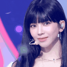 a close up of a woman 's face with a microphone on her ear