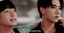 two young men are standing next to each other with one saying there 's the smart one