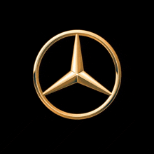a gold mercedes logo is against a black background