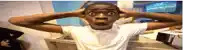 a man with a surprised look on his face is holding his head