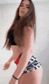 a woman in a black top and white shorts is dancing