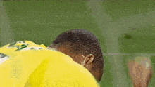 a soccer player wearing a yellow shirt with the number 3 on it