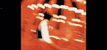 a blurry picture of a person walking through a tunnel of lights