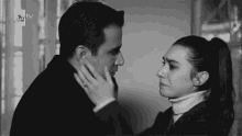 a black and white photo of a man and a woman looking at each other
