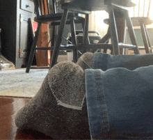 a person wearing a pair of gray socks and blue jeans