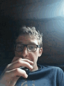 a man wearing glasses is talking on a cellphone