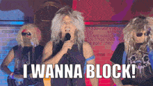 a man singing into a microphone with the words i wanna block
