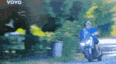 a man is riding a motorcycle down a road with the word voyo on the bottom