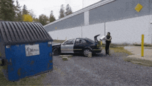 a dumpster that says ' demolition ' on it is next to a car