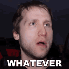 a man with a beard is making a funny face and the word whatever is above his face