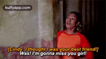 a woman in a red shirt is talking to another woman in a room .