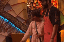a man and a woman are standing next to each other in front of a stage .