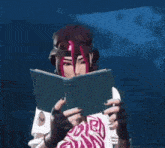 a woman with red hair is reading a book in a dark room