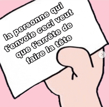 a hand holding a piece of paper that says la personne qui