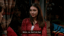a woman in a red shirt says hmm no don t do that