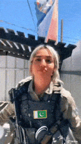 a woman in a military uniform has a patch on her vest that says c.
