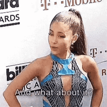 ariana grande is standing on a red carpet and talking to the camera .