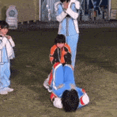 a group of children are playing a game on the grass .