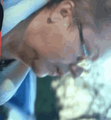 a close up of a person 's face wearing a hat and glasses