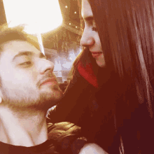 a man with a beard and a woman with long hair looking at each other