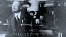 a black and white photo of a man with the words " and lenin is young once again " on the bottom