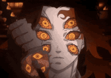 a close up of a person 's face with many eyes and chinese writing on them