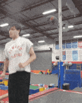 a man wearing a t-shirt that says athletics on it