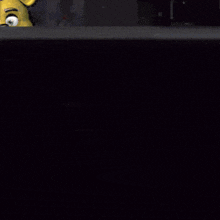 a man in a black shirt smiles in front of a screen that says ' ii '