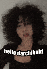 a woman with curly hair has the words hello darchibald on her face